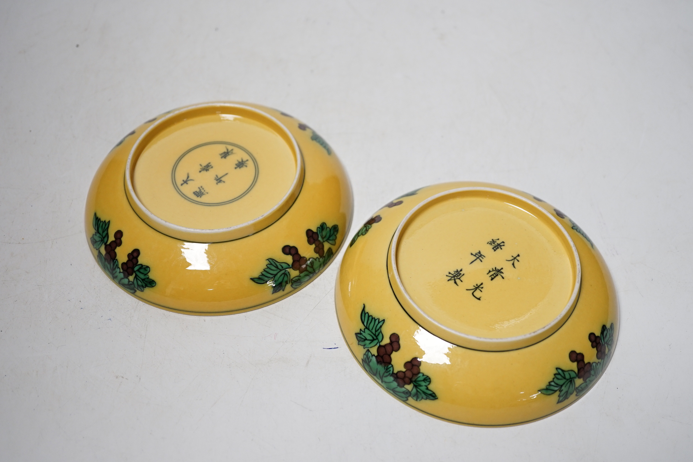 A pair of Chinese yellow glazed ‘dragon’ dishes, 13cm in diameter